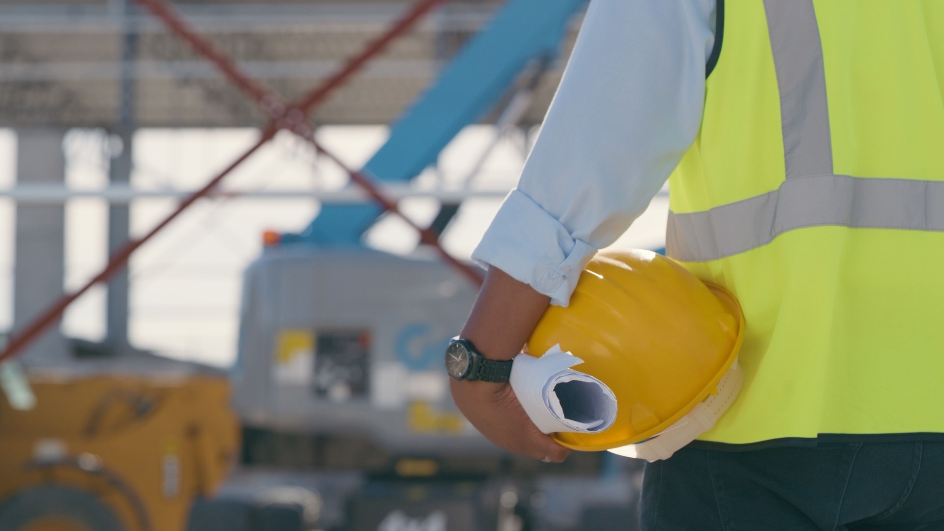 Hand, architect with blueprint and helmet at construction site. Project management, civil engineering and safety, hands of man engineer for building inspection, planning and maintenance